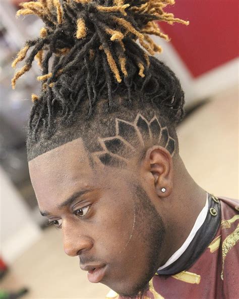 man bun definition: 1. . Man bun dreads fade